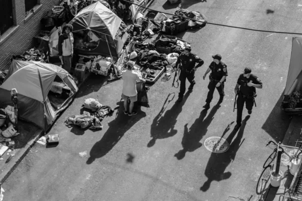 San Francisco Police Department officers walk by a homeless tent encampment along Willow Street in the Tenderloin district of San Francisco in 2020. | Source: Nick Otto for The Standard